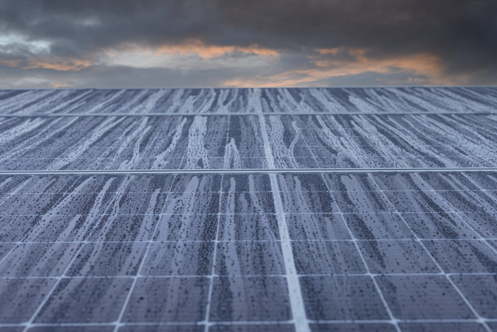 rain droplets rolling down a solar panel